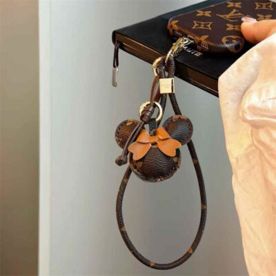 2026-05-11_085853_291 Luxury Monogram Case with Bow Charm & Wrist Lanyard for iPhone 12-18 Pro & Pro Max