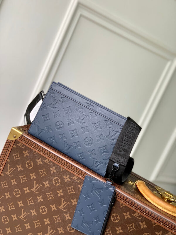 POCHETTE VOYAGE 22 IN DARK BLUE MONOGRAM SHADOW CALFSKIN